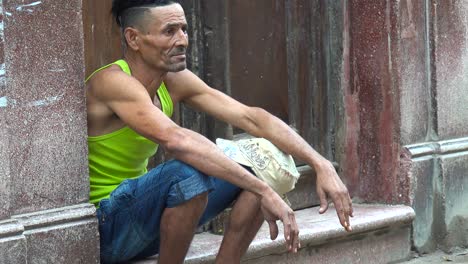 A-man-on-the-street-watches-passersby-in-Havana-Cuba