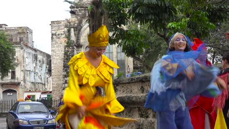 Women-in-colorful-costumes-dance-on-stilts-on-the-streets-of-Havana-Cuba