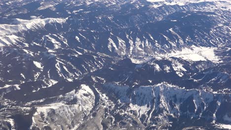 Aerial-shot-over-the-Rocky-Mountains-in-snow-in-winter