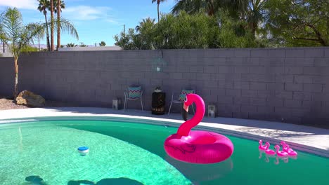 An-artificial-inflatable-flamingo-floats-in-a-swimming-pool-at-a-Palm-Springs-home