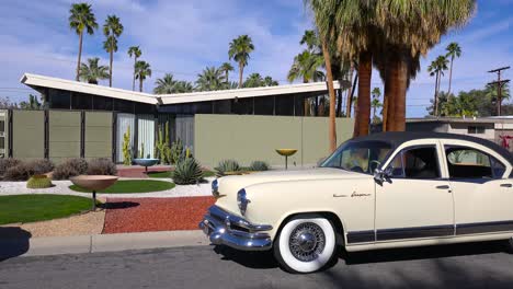 Exterior-establishing-shot-of-a-Palm-Springs-California-mid-century-modern-home-with-classic-retro-cars-parked-outside