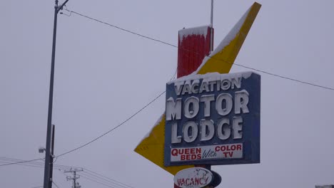 A-snow-covered-sign-reads-Vacation-Motor-Lodge