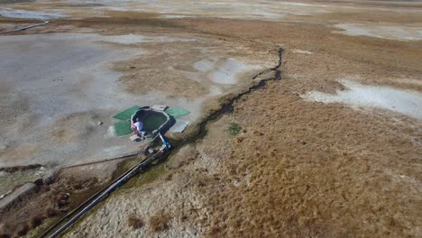 An-aerial-over-a-man-in-a-natural-hot-pool-in-the-Sierra-Nevada-mountains-near-Mammoth-California--1