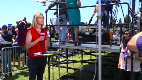 A-CNN-reporter-speaks-in-front-of-the-camera-at-a-political-rally-1