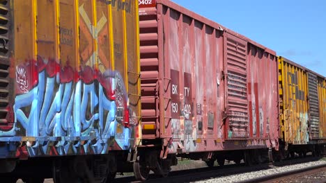 Colorful-graffiti-is-seen-on-parked-railway-boxcars