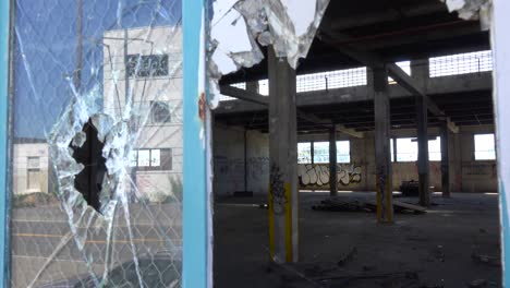 Interior-of-an-old-factory-or-warehouse-with-broken-window-foreground