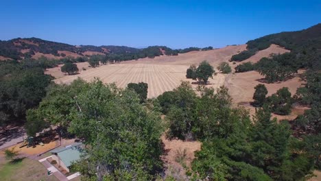 Aerial-footage-of-the-rolling-hills-oak-trees-and-farms-of-Central-California
