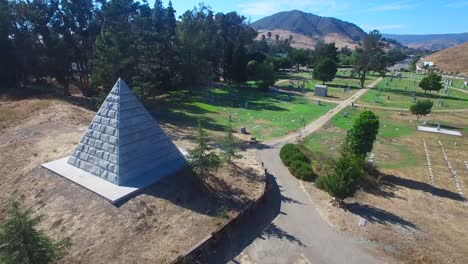 An-aerial-shot-over-a-large-stone-pyramid-in-a-cemetery-near-San-Luis-Obispo-California-1