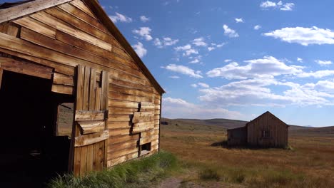 Old-wooden-barns-sit-in-the-grasslands-at-the-abandoned-ghost-town-of-Bodie