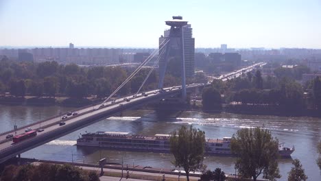 A-ferry-boat-maneuvers-on-the-Danube-River-with-the-modern-bridge-at-Bratislava-Slovakia-background-1