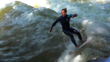 Surfers-brave-the-rapids-of-the-Eisbach-River-in-Munich-Germany-1