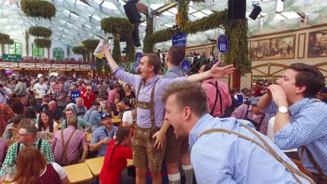 Drunken-men-celebrate-in-a-beer-hall-during-Oktoberfest-in-Germany