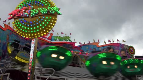 A-tilt-a-whirl-style-ride-and-an-amusement-park-spins-in-circles