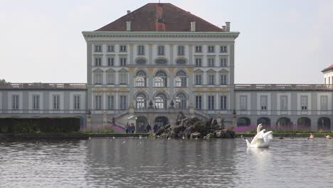 Swans-move-across-a-pond-in-front-of-Nymphenburg-Palace-in-Munich-Germany-1