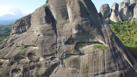 Beautiful-aerial-as-climbers-ascend-a-sheer-rocky-cliff-face-in-Meteora-Greece-4