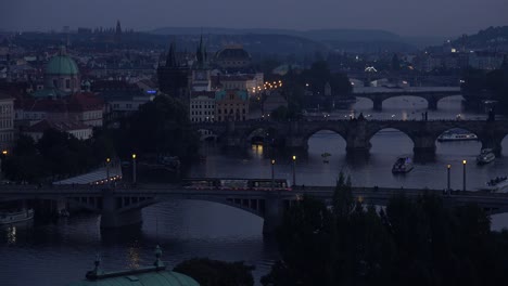 Beautiful-night-establishing-shot-of-boats-along-the-Vltava-River-in-Prague-Czech-Republic