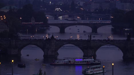 Beautiful-night-establishing-shot-of-boats-along-the-Vltava-River-in-Prague-Czech-Republic-1