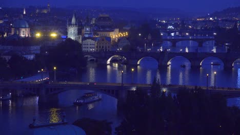Beautiful-night-establishing-shot-of-boats-along-the-Vltava-Río-in-Prague-Czech-Republic-3