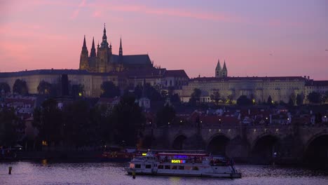 Beautifulsunset-establishing-shot-of-boats-along-the-Vltava-River-in-Prague-Czech-Republic