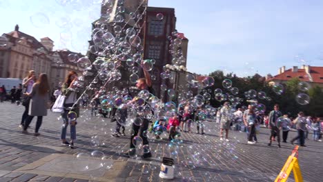 A-street-performer-blows-giant-bubbles-in-a-square-in-Prague-Czech-Republic
