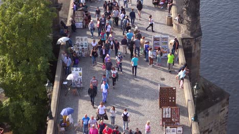 Crowds-moving-across-the-Charles-Bridge-into-the-old-city-in-Prague-Czech-Republic