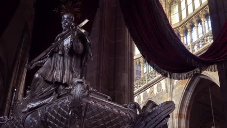 A-statue-stands-in-the-beautiful-St-Vitus-Cathedral-in-Prague-Czech-Republic