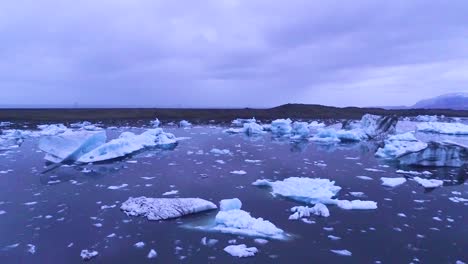 Drone-aerial-over-icebergs-in-a-glacial-bay-suggest-global-warming-in-the-Arctic-at-Jokulsarlon-glacier-lagoon-Iceland-night-3
