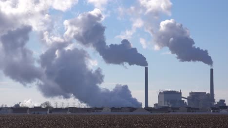 Huge-polluting-smokestacks-belch-CO2-into-the-atmosphere-suggest-pollution-carbon-emissions-and-global-warming
