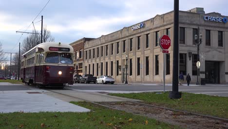 A-historic-tram-or-electric-trolley-passes-through-downtown-Kenosha-Wisconsin-in-this-establishing-shot