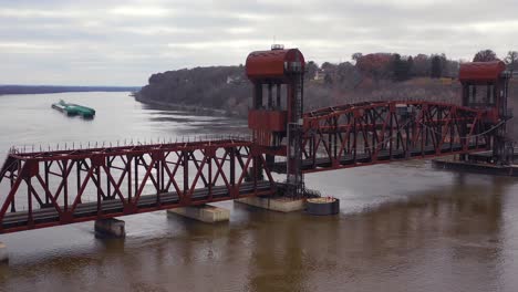 Drone-aerial-footage-of-a-drawbridge-on-the-Mississippi-slowly-opening-to-make-way-for-a-huge-barge-traveling-upstream