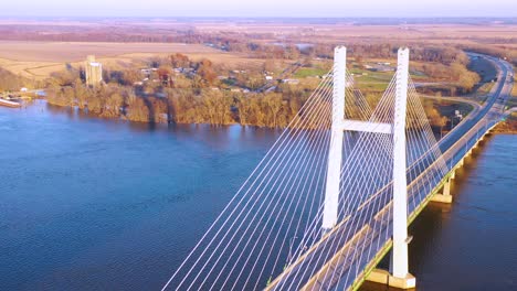 A-drone-aerial-of-cars-and-trucks-crossing-a-bridge-over-the-Mississippi-River-at-Burlington-Iowa-suggesting-infrastructure-shipping-trucking-or-transportation-2