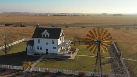 A-high-angle-establishing-shot-of-a-classic-farmhouse-farm-and-barns-in-rural-midwest-America-York-Nebraska