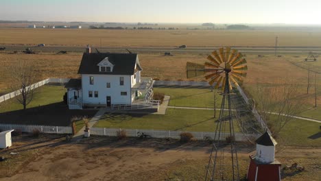 A-drone-aerial-establishing-shot-of-a-classic-farmhouse-farm-and-barns-in-rural-midwest-America-York-Nebraska-2