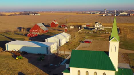 A-drone-aerial-establishing-shot-over-a-classic-beautiful-farmhouse-farm-and-barns-in-rural-midwest-America-York-Nebraska-6