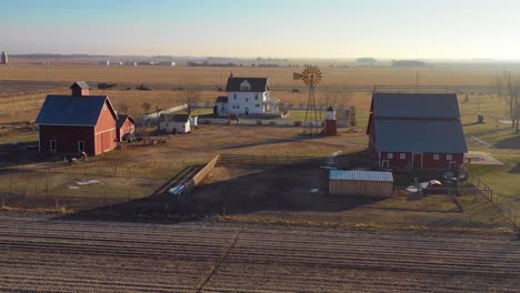 A-drone-aerial-establishing-shot-over-a-classic-beautiful-farmhouse-farm-and-barns-in-rural-midwest-America-York-Nebraska-11