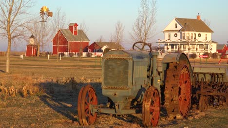 Establishing-shot-of-a-classic-beautiful-small-town-farmhouse-farm-tractor-and-barns-in-rural-midwest-America-York-Nebraska