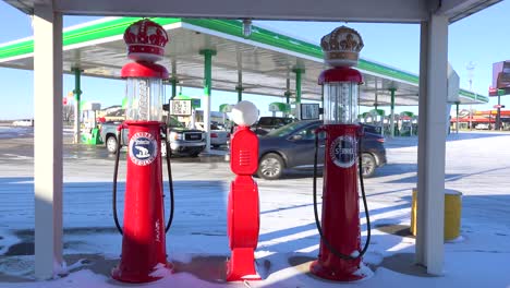 Old-gas-pumps-sit-beside-a-modern-gas-station-at-a-truck-stop-in-Iowa