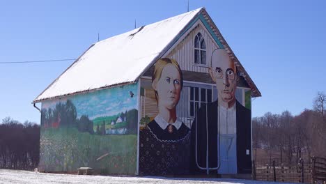 A-rural-barn-has-a-rendition-of-Grant-Wood's-American-Gothic-painting-on-the-side