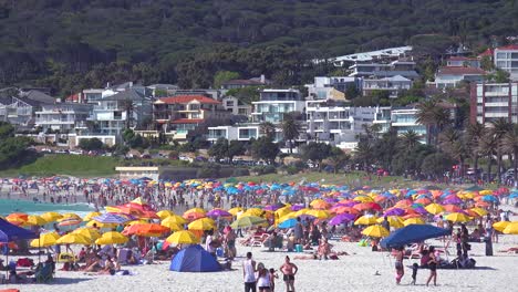 Establishing-shot-of-a-beautiful-busy-holiday-beach-scene-at-Camps-Bay-Cape-Town-South-Africa