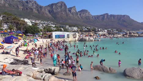 A-crowded-and-busy-holiday-beach-scene-at-Camps-Bay-Cape-Town-South-Africa-with-Twelve-Apostles-mountains-background-1