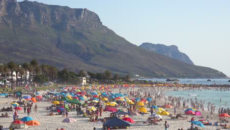 A-crowded-and-busy-holiday-beach-scene-at-Camps-Bay-Cape-Town-South-Africa-with-Twelve-Apostles-mountains-background-4
