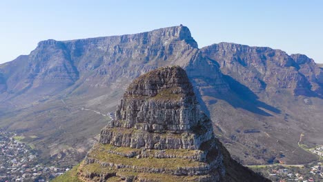 Amazing-aerial-shot-over-the-top-of-Lion's-Head-peak-with-Table-Mountain-background-in-Cape-Town-South-Africa