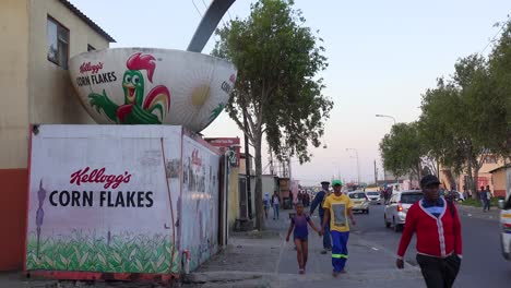 A-bowl-of-Kellog\'s-corn-flakes-stands-beside-a-busy-downtown-street-in-the-South-Africa-township-of-Gugulethu