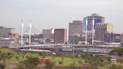 Establishing-shot-of-Johannesburg-South-Africa-with-Nelson-Mandela-bridge-and-passenger-train-foreground-2