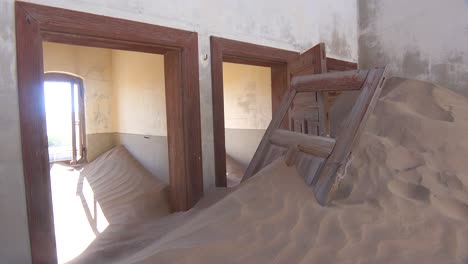 Sand-blows-through-an-abandoned-building-in-the-gem-mining-ghost-town-of-Kolmanskop-Namibia-3