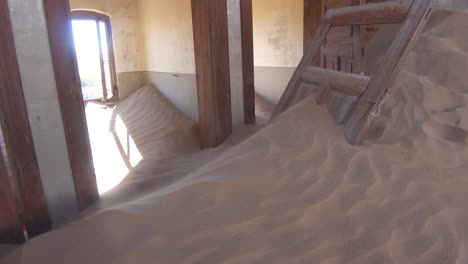 Sand-blows-through-an-abandoned-building-in-the-gem-mining-ghost-town-of-Kolmanskop-Namibia-4