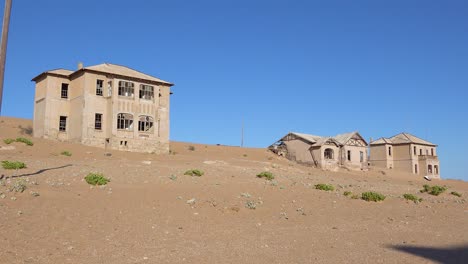 Exterior-establishing-shot-of-abandoned-buildings-in-the-Namib-desert-at-the-ghost-town-of-Kolmanskop-Namibia-3