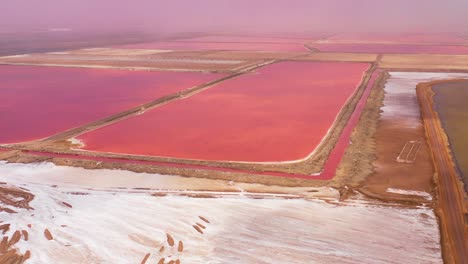 Beautiful-aerial-over-bright-red-and-pink-salt-pan-farms-near-Walvis-Bay-Namibia