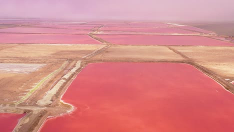Beautiful-aerial-over-bright-red-and-pink-salt-pan-farms-near-Walvis-Bay-Namibia-1
