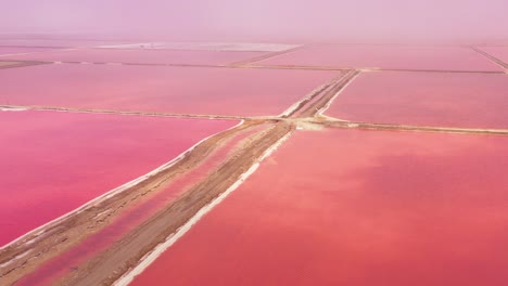 Beautiful-aerial-over-bright-red-and-pink-salt-pan-farms-near-Walvis-Bay-Namibia-3